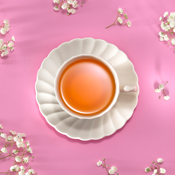Food photography still life image of cup of tea on pink background