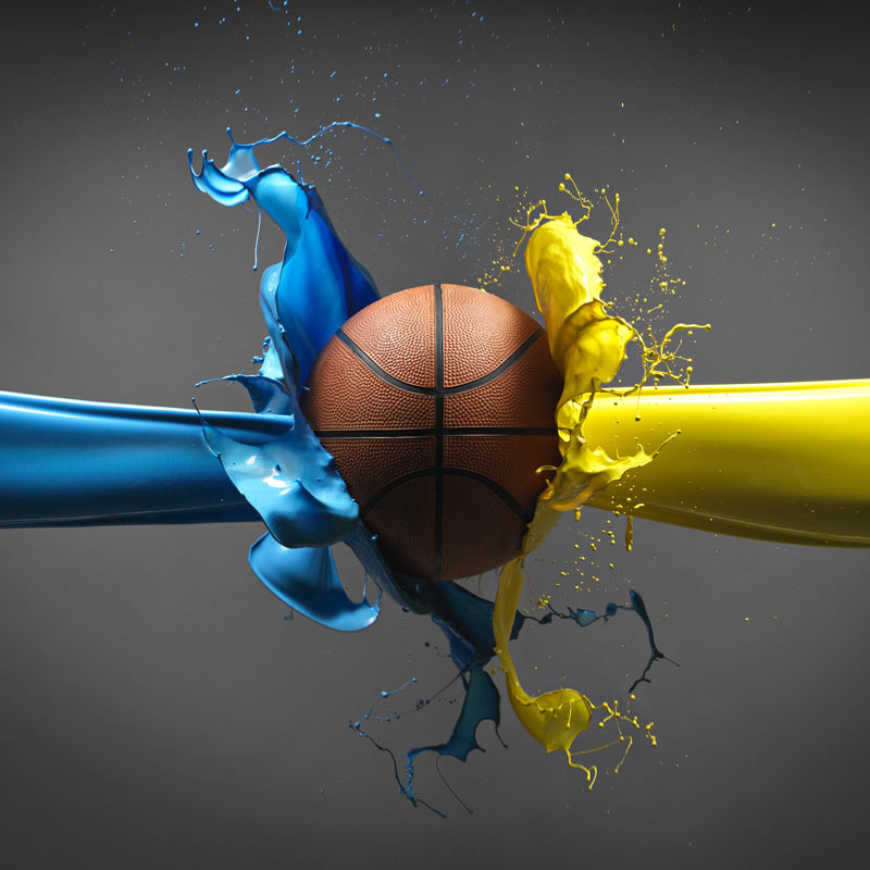 Basketball with blue and yellow paint splashes from the side
