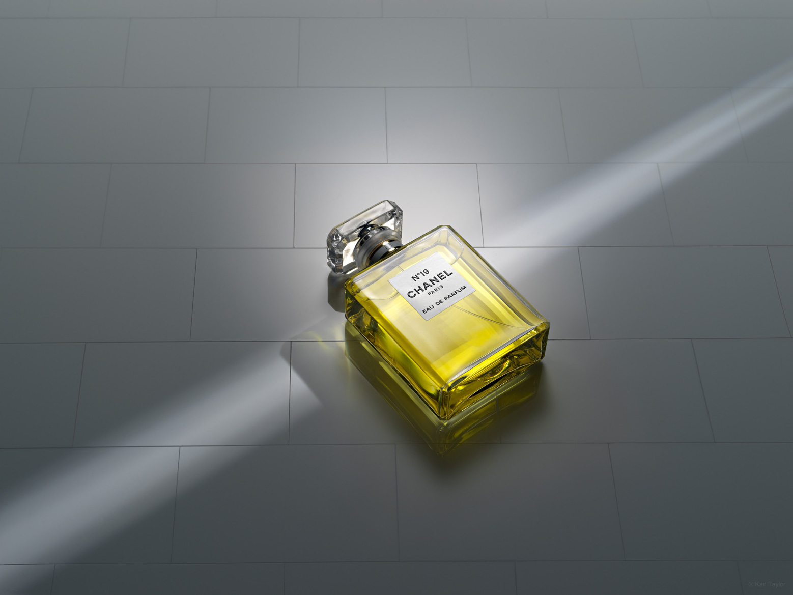 Chanel No.19 perfume bottle in ray of light