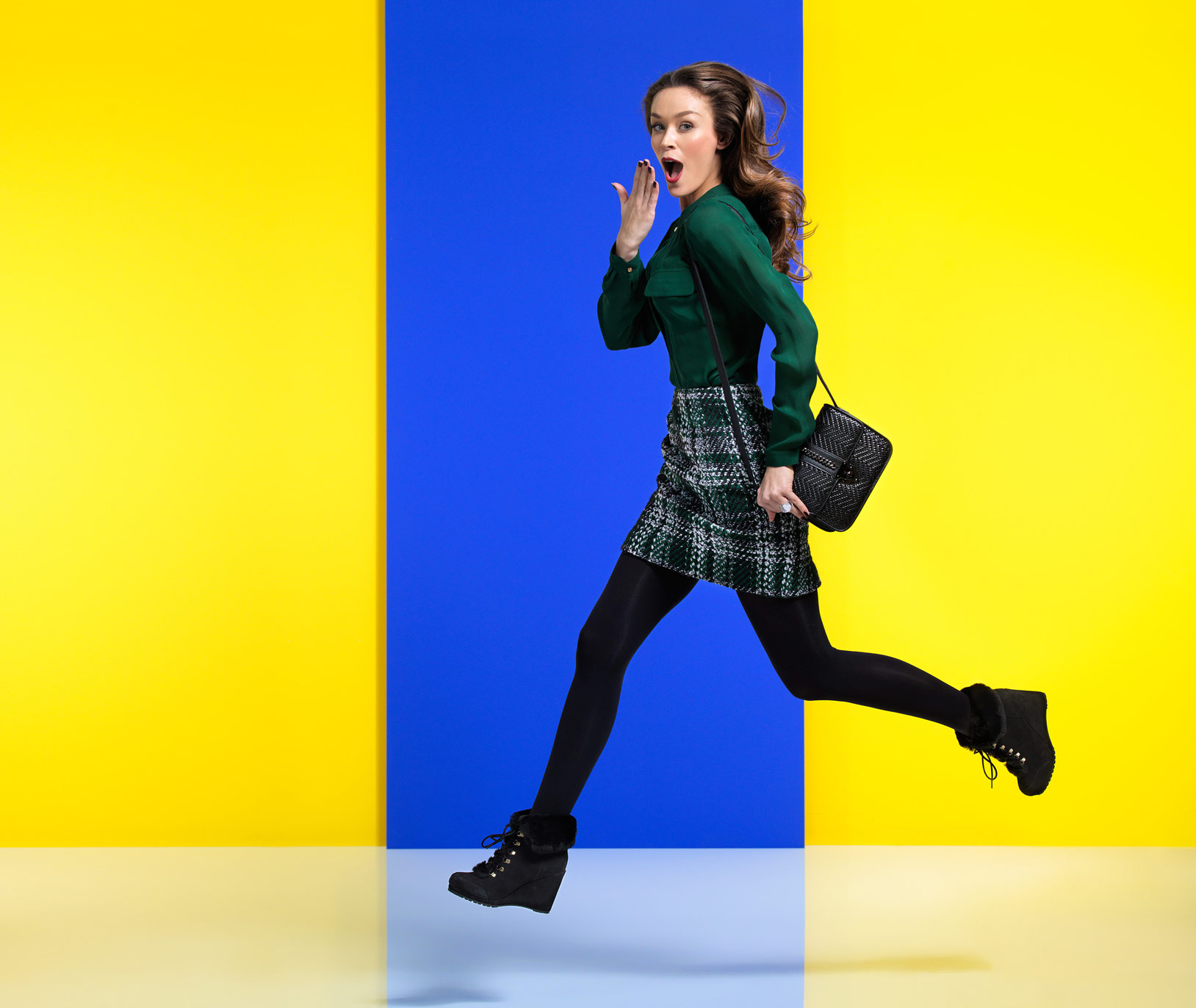 Model running against yellow and blue background