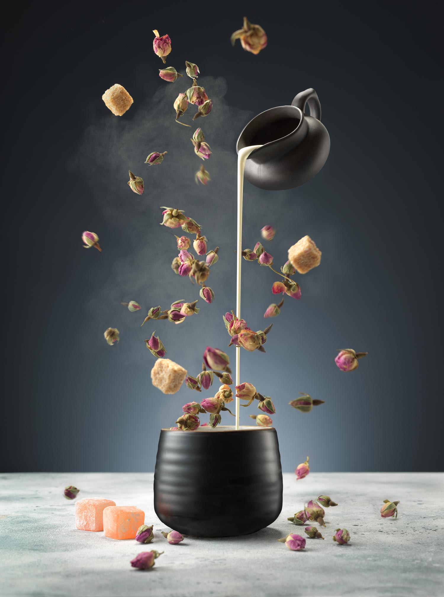 An image of a cup with elements needed to make a flower tea exploding out of the cup 