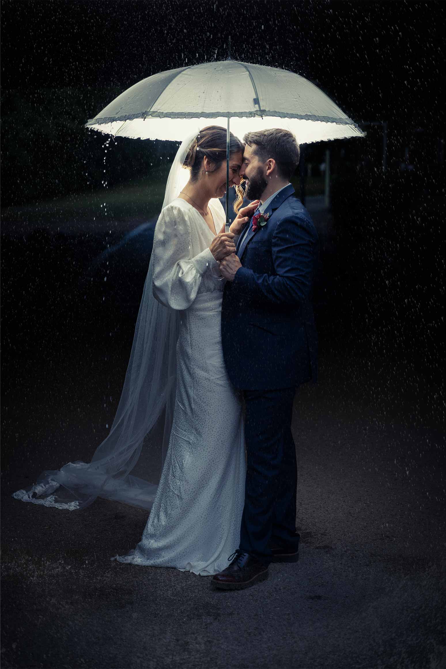 Newlyweds under an umbrella